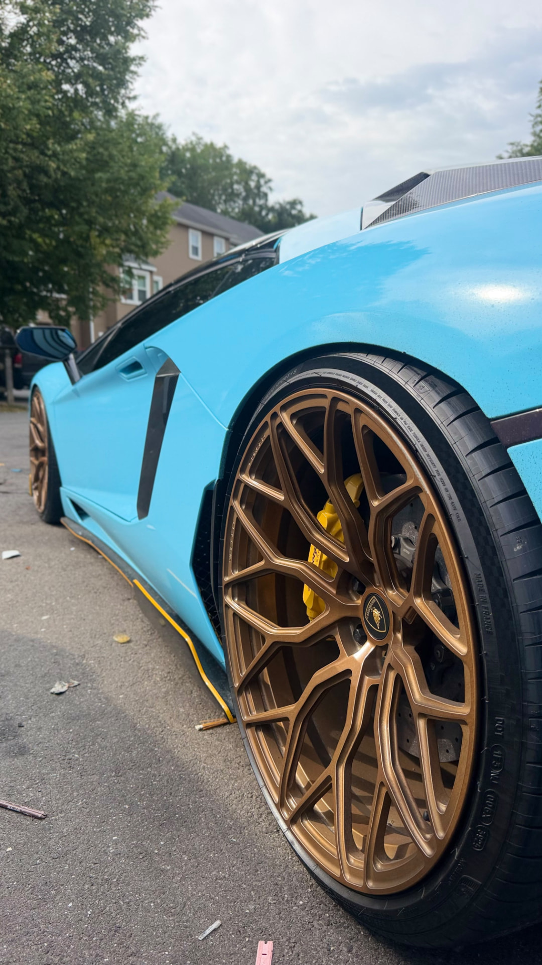 Baby blue Lamborghini with bronze wheels after detail