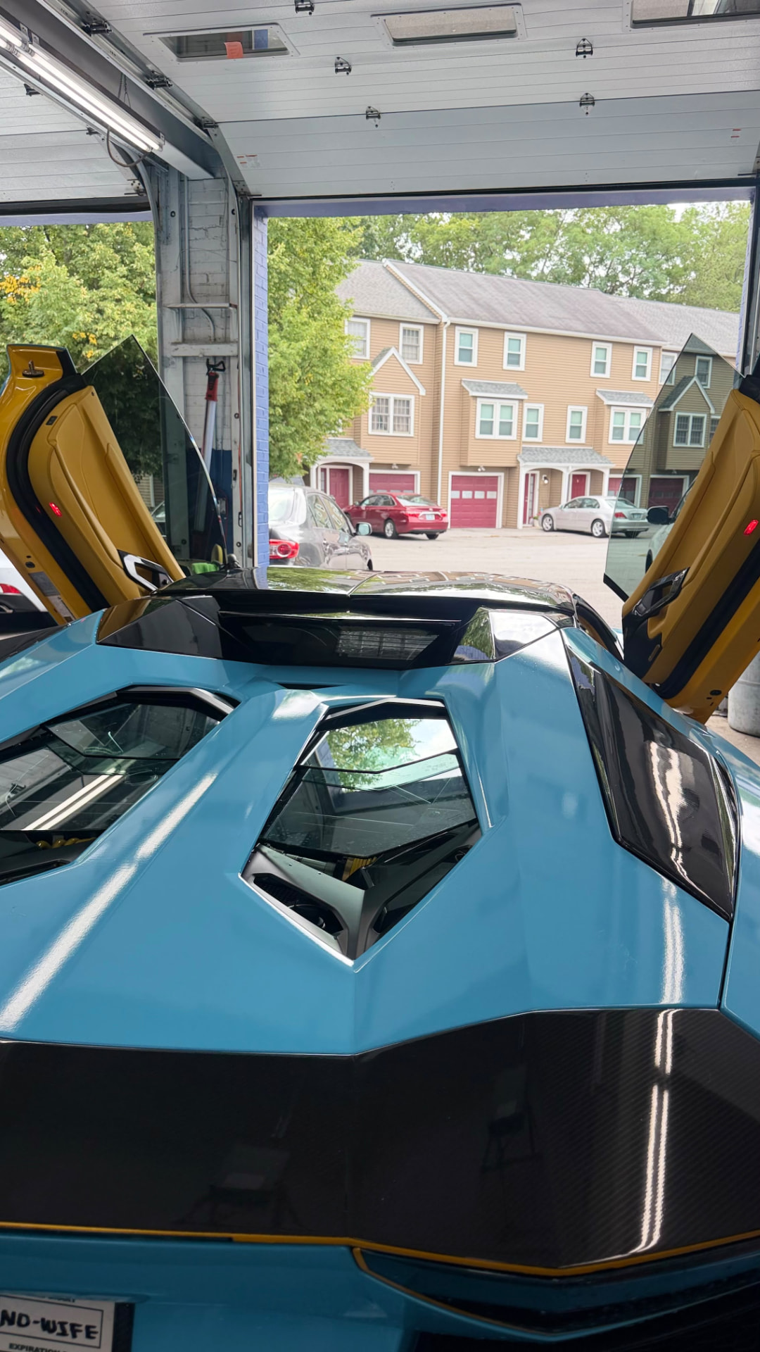 Lamborghini engine cover detailed in the shop